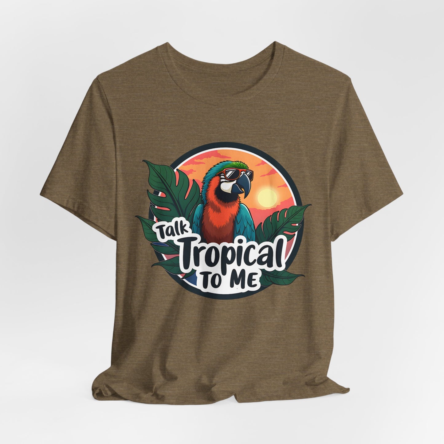 The Tropical Parrot Tee - Talk Tropical to Me Unisex Jersey Short Sleeve Shirt features a brown design with a parrot in sunglasses, tropical leaves, and a sunset, plus the text “Talk Tropical To Me” for vibrant island vibes.