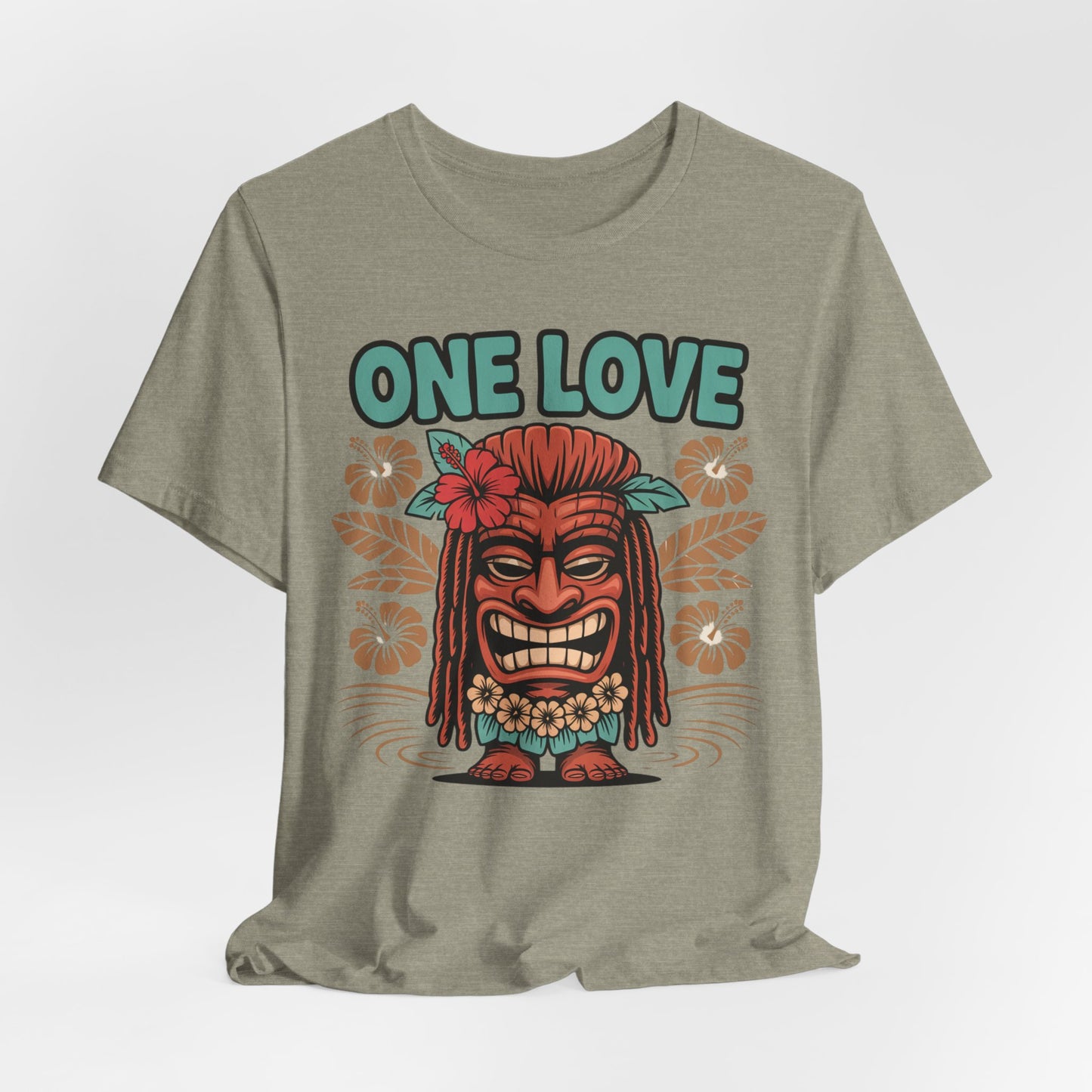 The One Love Tropical Unisex Jersey Tiki T-Shirt features a vibrant tiki face with red hair, floral accents, and ONE LOVE above—ideal for beach lovers and festival-goers seeking a bold tropical vibe.