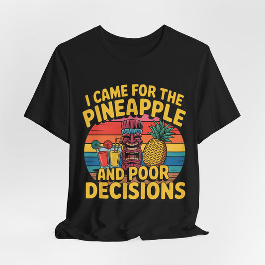 The Tropical Humor Tiki T-Shirt features a vibrant tiki face, pineapple, drinks, and a retro sunset, with bold yellow text: “I Came for the Pineapple and Poor Decisions”—a perfect unisex pick for summer or casual gatherings.