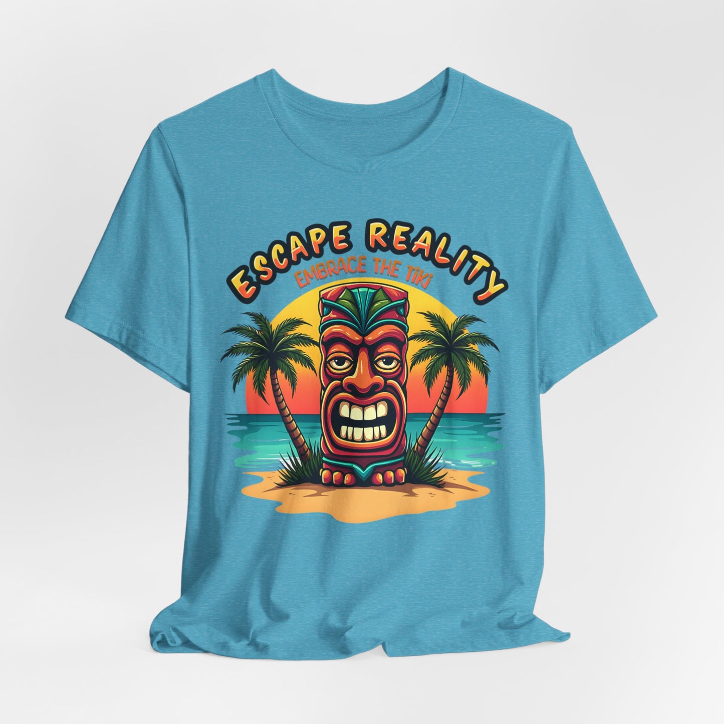 The Escape Reality Unisex Tiki T-Shirt features a vibrant tiki face on a beach at sunset with Escape Reality and Embrace the Tiki text—ideal for summer and tropical getaways.
