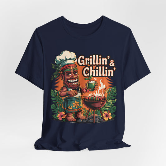 Grilln & Chilln Unisex Jersey Tiki T-shirt—featuring a smiling cartoon tiki chef and flowers with Grillin & Chillin above—perfect for summer BBQs and luau parties.