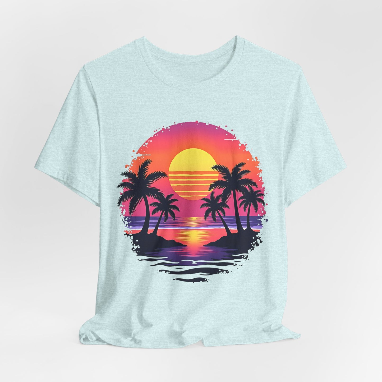 The Tropical Sunset Graphic T-Shirt is a light blue unisex jersey short sleeve shirt featuring a vibrant sunset with silhouetted palm trees, capturing colorful summer vibes over the ocean.