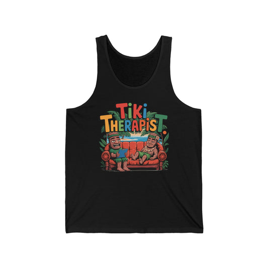 The Tiki Therapist Unisex Jersey Tiki Tank Top – Fun Summer Vibes features a vibrant design of two tiki figures on a couch with Tiki Therapist text, all surrounded by tropical leaves, crafted from a high-quality cotton blend.