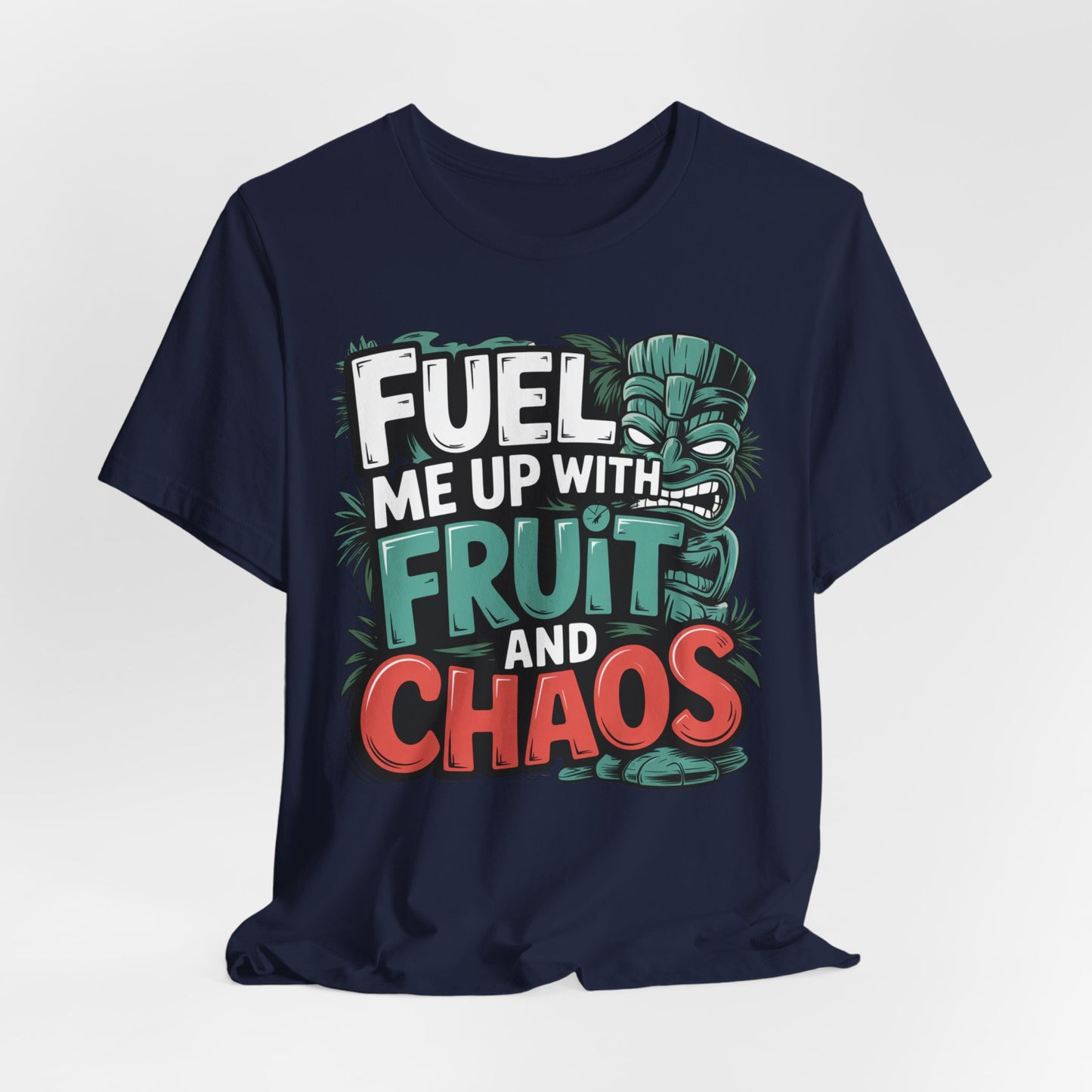 The Fuel Me Up With Fruit and Chaos Unisex Jersey Tiki T-Shirt is a navy blue tee with a colorful tiki face and bold Fuel me up with fruit and chaos text—perfect for anyone seeking a vibrant, fun graphic shirt for summer adventures.