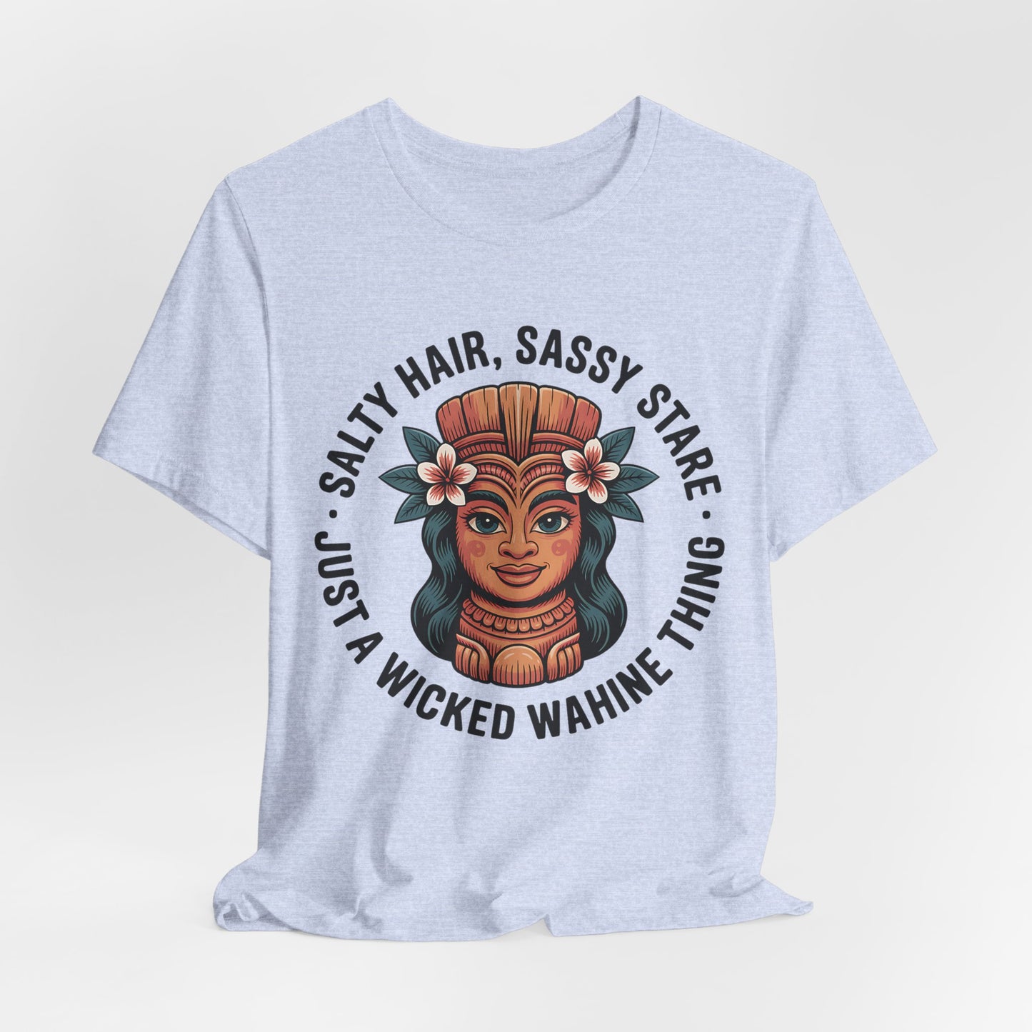 The Wicked Wahine Graphic T-Shirt - Salty Hair, Sassy Stare T-Shirt features a colorful tiki woman with flowers in her hair and the phrase Salty hair, sassy stare. Perfect for beach trips or nature lovers!.