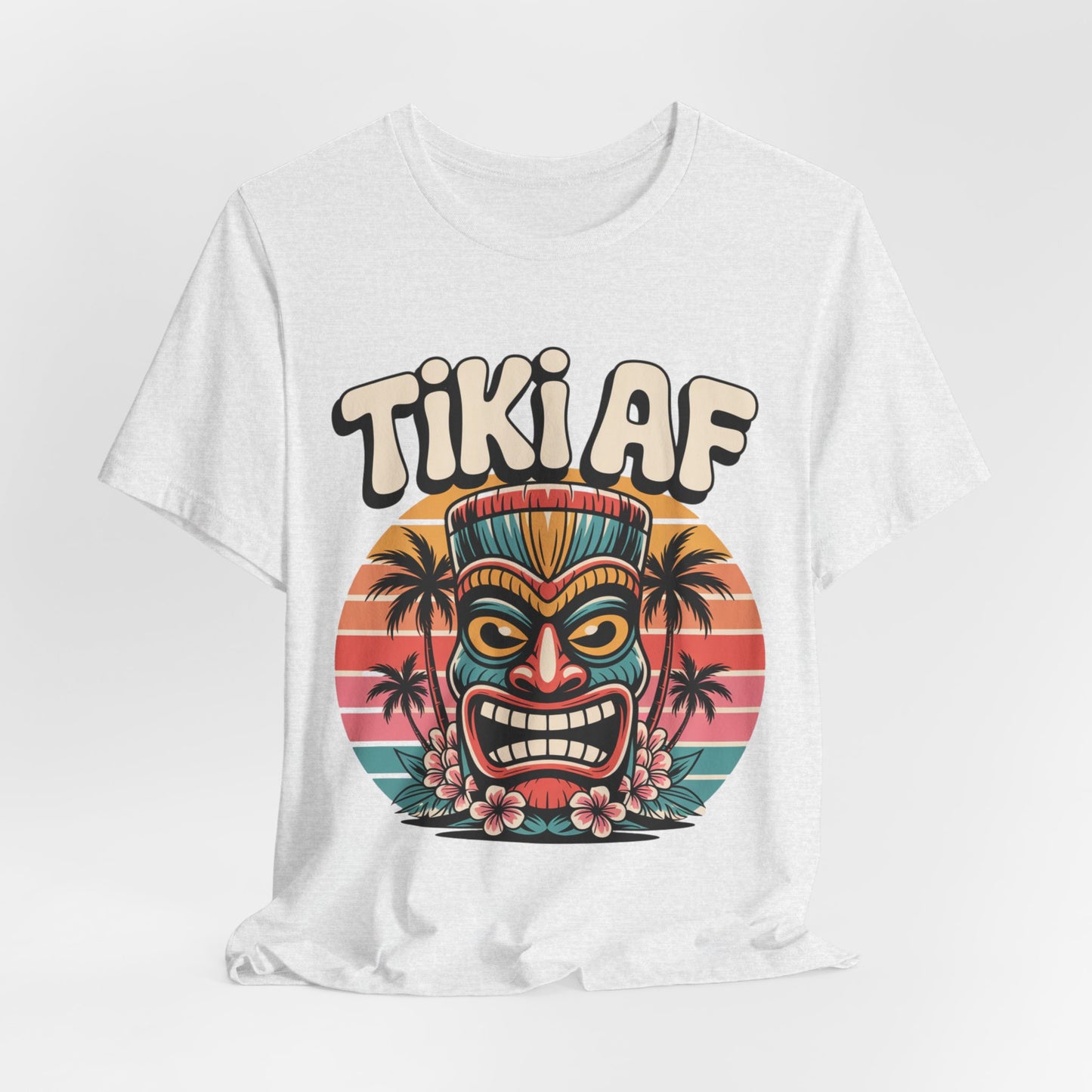 The Tiki AF Unisex Jersey Short Sleeve T-Shirt showcases a vibrant tiki mask, tropical flowers, palm trees, and sunset backdrop with bold TIKI AF text—ideal for beach lovers and fans of tropical vibes.