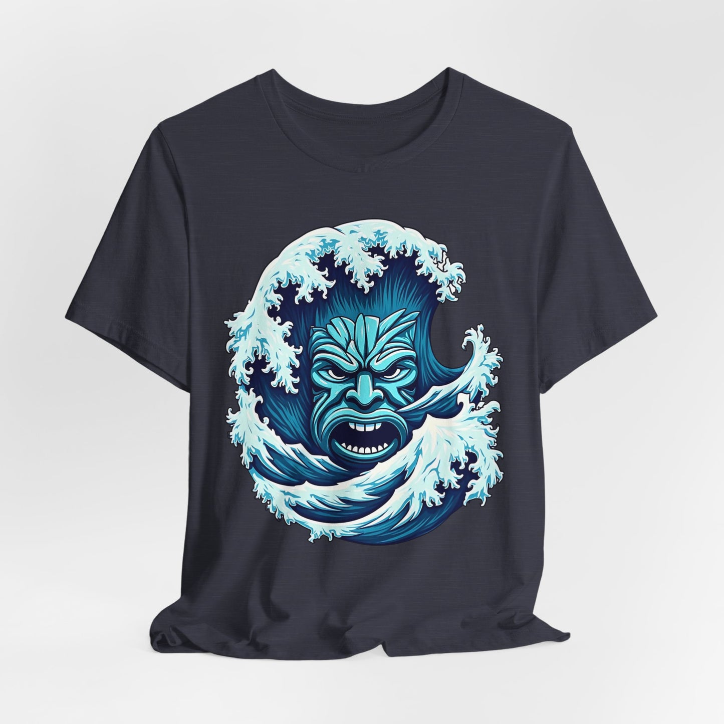 The Ocean Wave Tiki-Adventure Vibes Unisex Jersey T-Shirt features a bold blue wave with a tribal face design, perfect for beach lovers. Made from soft Airlume cotton for comfort and style.