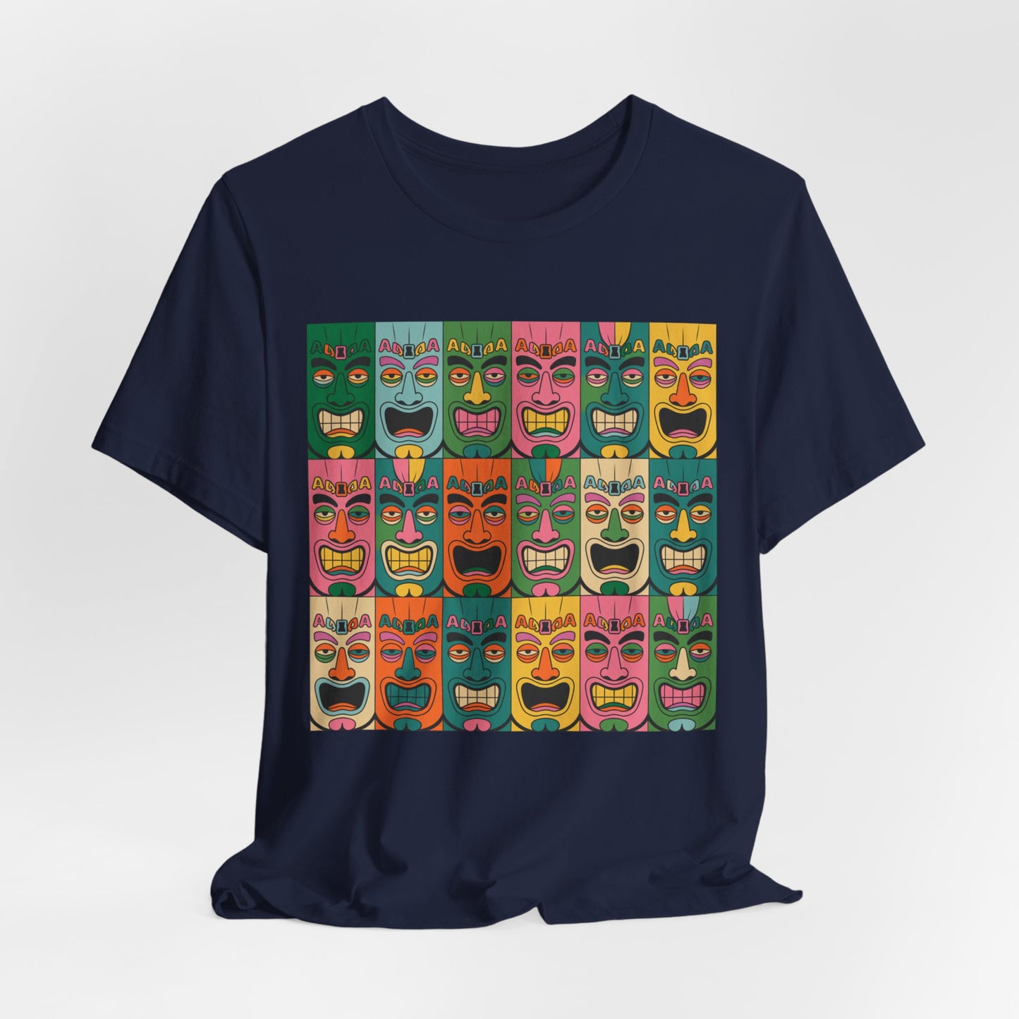 The Vibrant Tribal Mask Unisex Tiki T-Shirt in navy blue features bold, colorful cartoon tiki faces on the front and is crafted with eco-friendly manufacturing for standout style that feels good.