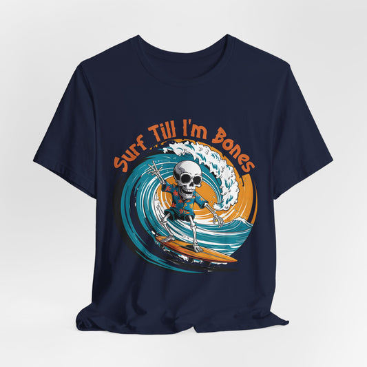 The Surf Till Im Bones Unisex Jersey Tee is a navy blue shirt with a playful skull surfing graphic and Surf Till Im Bones in orange—ideal for beach lovers.