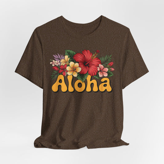 The Aloha Floral Unisex Jersey T-Shirt features a bold yellow Aloha design with vibrant hibiscus and plumeria on soft Airlume cotton, perfect for tropical vibes and casual summer style.