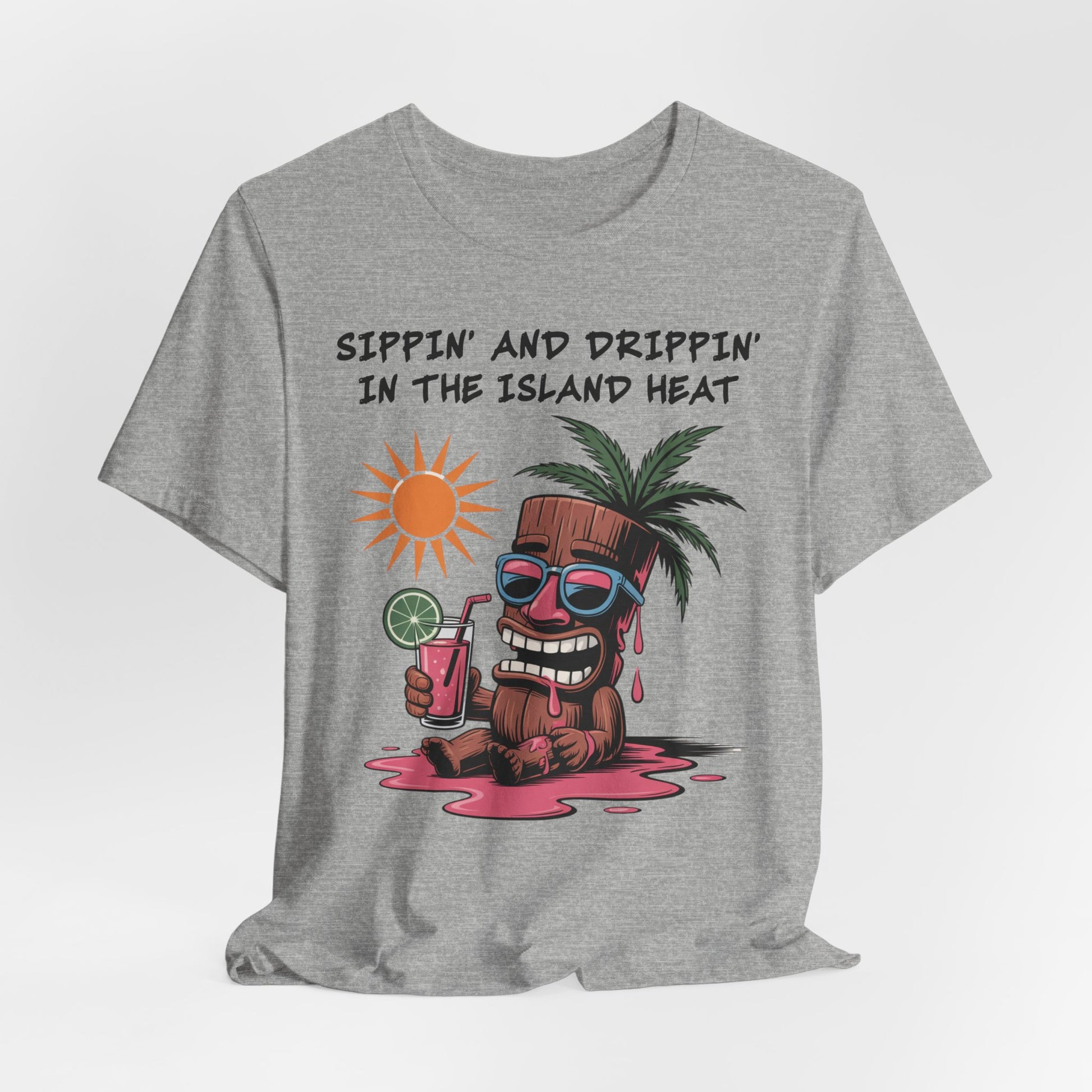 The Tropical Vibes Tiki T-Shirt—Sippin’ and Drippin’ in the Island Heat—is a gray unisex tee with a cartoon coconut in shades, sweating and holding a pink drink under the sun for a perfect island vibe.
