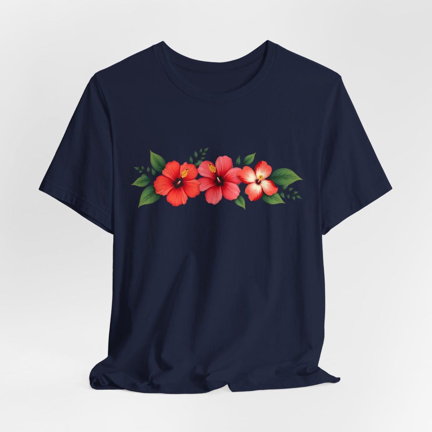 The Floral Unisex Short Sleeve T-Shirt—crafted from 100% Airlume cotton—features three red hibiscus flowers with green leaves across the chest, making it perfect for spring, summer, and casual outings.