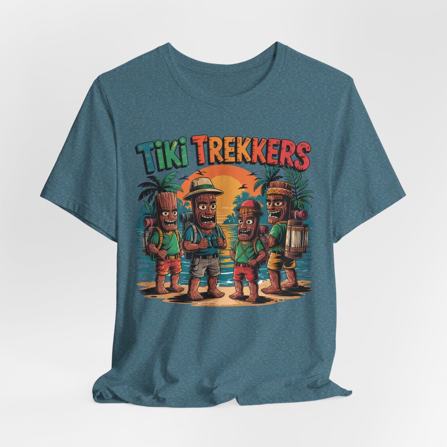 The Tiki Trekkers Graphic Tiki T-Shirt - Unisex Jersey Short Sleeve Shirt features four cartoon tiki figures in traveler outfits on a beach at sunset, with Tiki Trekkers above—ideal for adventure lovers and outdoor enthusiasts.