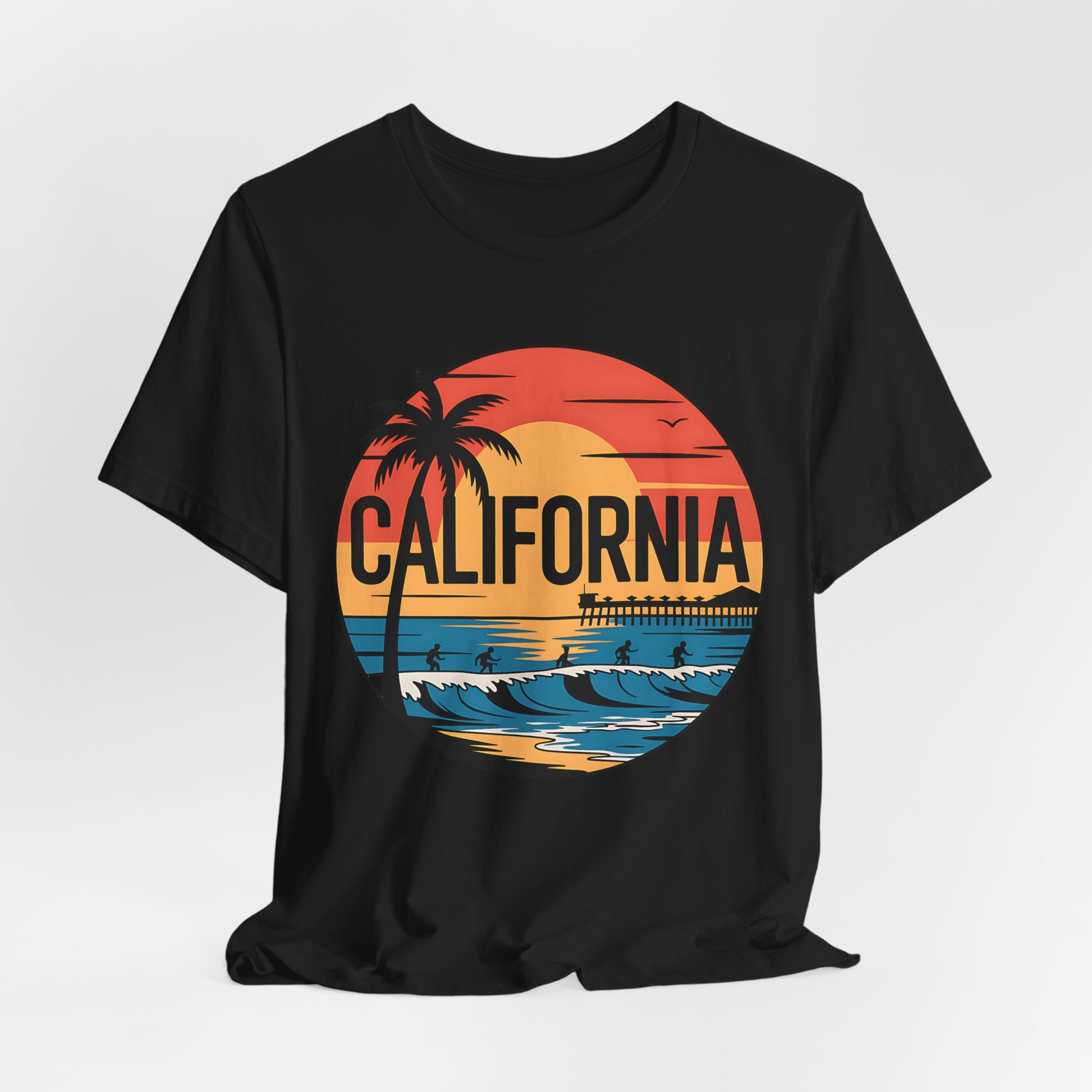 The California Sunset Graphic T-Shirt is a black unisex jersey short sleeve tee with a retro sunset, palm tree, ocean waves, pier, and birds design plus bold CALIFORNIA—made from breathable cotton and perfect for summer wear.
