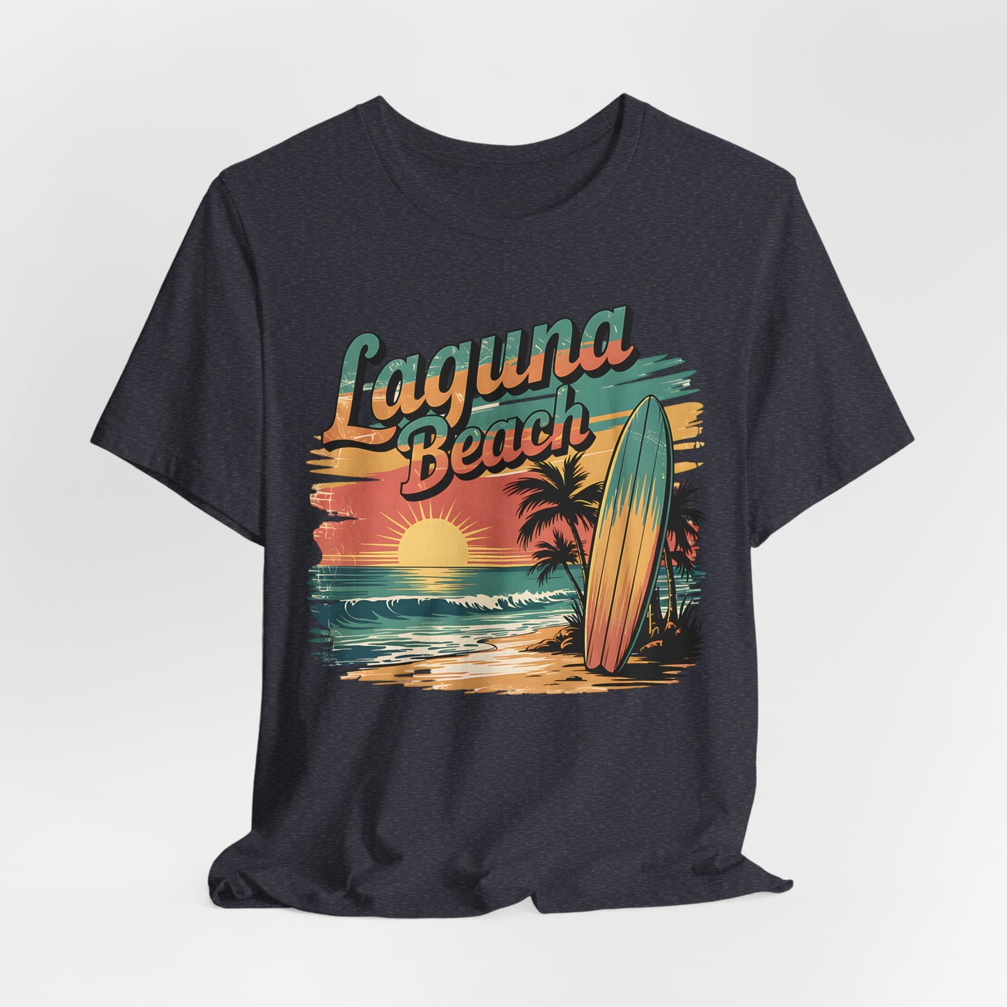 The Laguna Beach Surf Tee - Unisex Jersey Short Sleeve Shirt features a vibrant sunset, ocean, palm trees, surfboard, and bold “Laguna Beach” text—ideal for beach lovers and fans of coastal style.