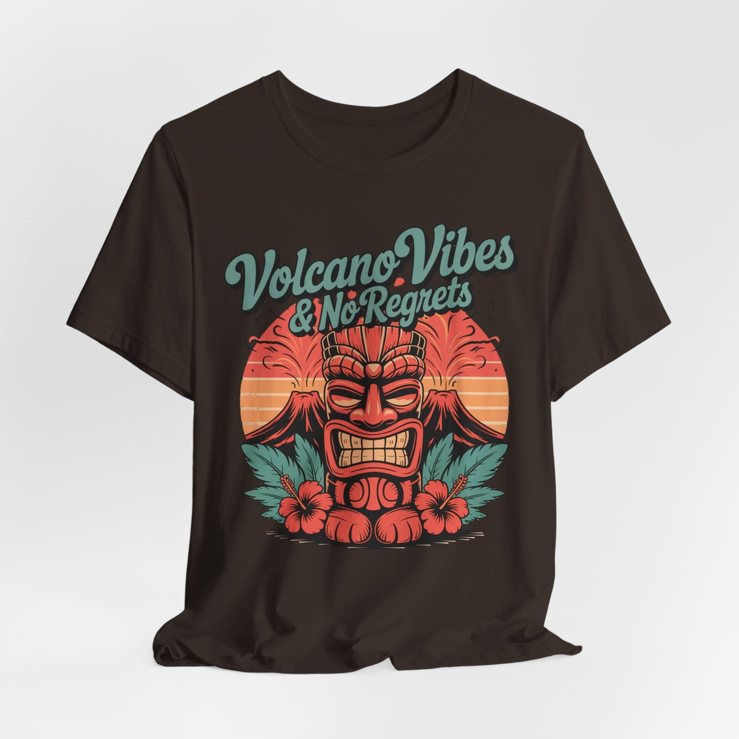 The Volcano Vibes and No Regrets Unisex Tiki T-Shirt features a colorful tiki mask, tropical leaves, hibiscus, and an orange sunset—bold retro graphic for summer adventures and a standout addition to any shirt collection.