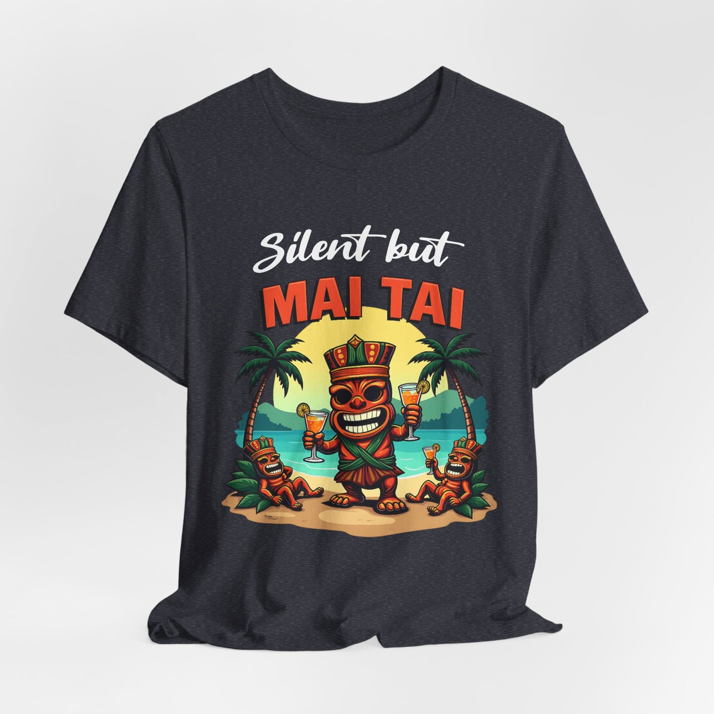 The Mai Tai Graphic Unisex Jersey Tiki T-Shirt features a colorful cartoon tiki holding drinks with two smaller tikis on a beach, palm trees, and Silent but MAI TAI text. Perfect for tropical vibes and your next vacation!.