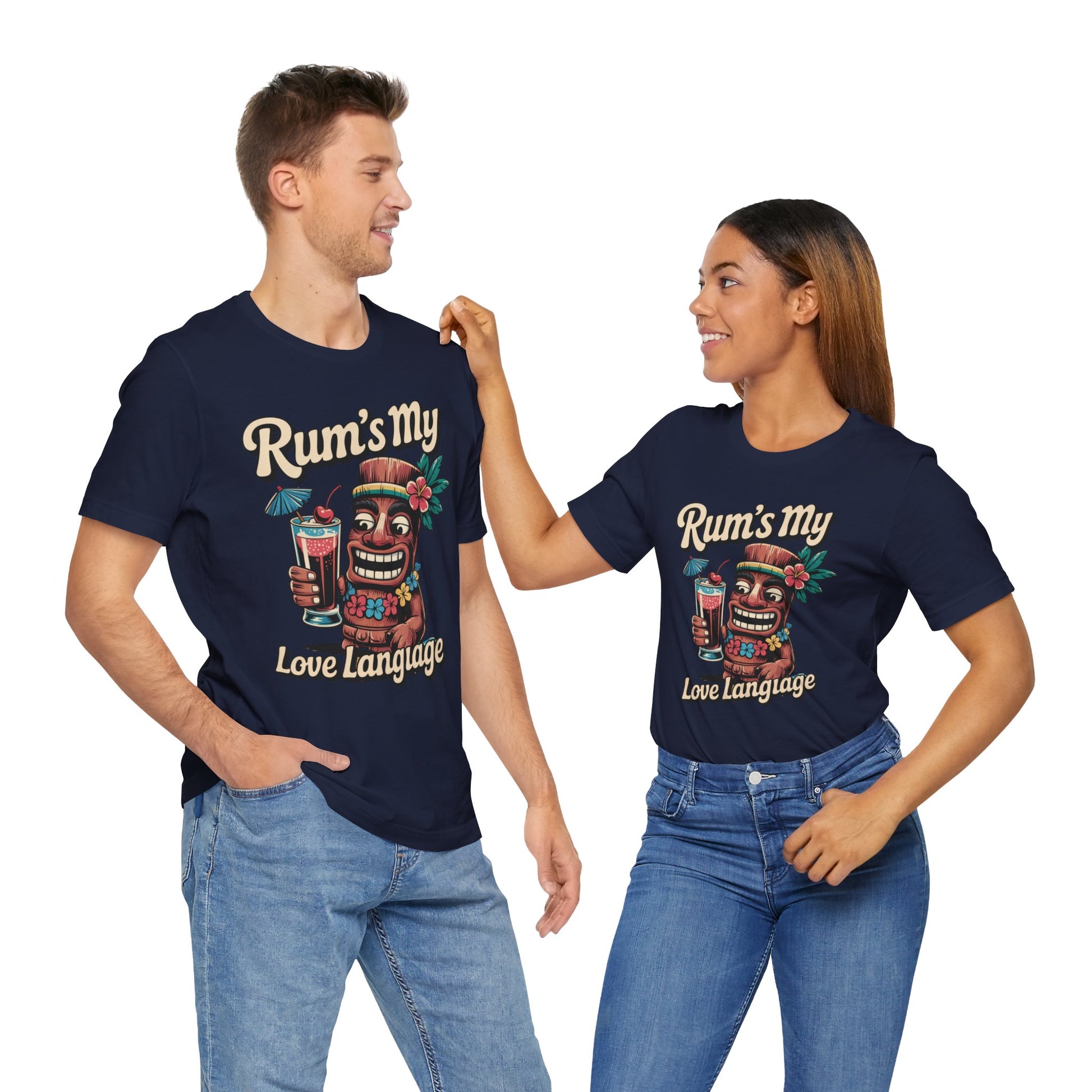 A man and woman wear matching Tropical Rum Themed Tiki T-Shirts – Rums My Love Language unisex tees with vibrant prints, smiling at each other and capturing tropical vibes against a white background.