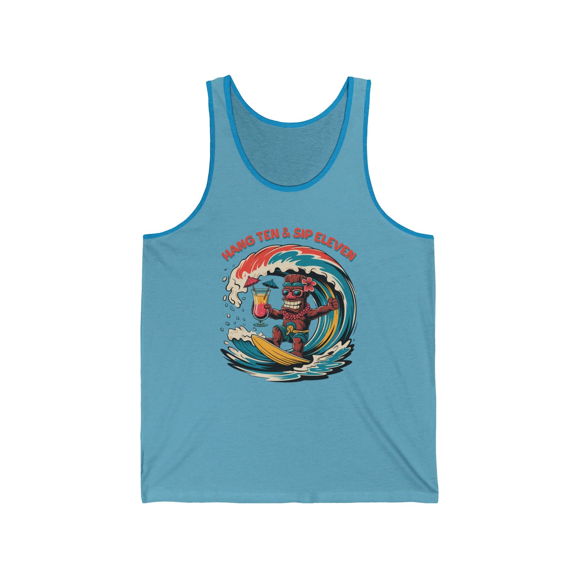 The Hang Ten and Sip Eleven Tiki Tank Top is a light blue unisex jersey featuring a cartoon tiki surfing with a drink. “Hang Ten & Sip Eleven” appears above in red text. Made from soft Airlume combed cotton for comfort.