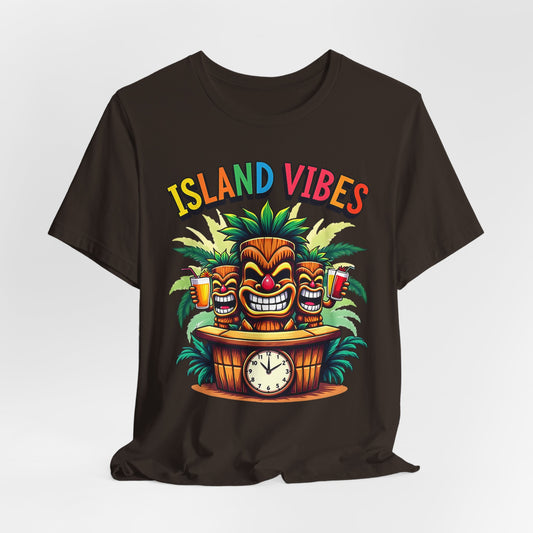 The Island Vibes Tiki T-Shirt - Unisex Relaxed Fit features a black jersey with colorful tiki masks, palm leaves, fun drinks, a clock, and rainbow ISLAND VIBES text—perfect for tropical lovers and embracing the island lifestyle.