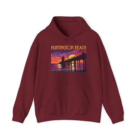 The Huntington Beach Sunset Hoodie | Unisex Heavy Blend™ Sweatshirt features a cozy maroon design with a vibrant sunset pier graphic and HUNTINGTON BEACH above—showcasing bold yellow, orange, pink, and purple for standout casual style.