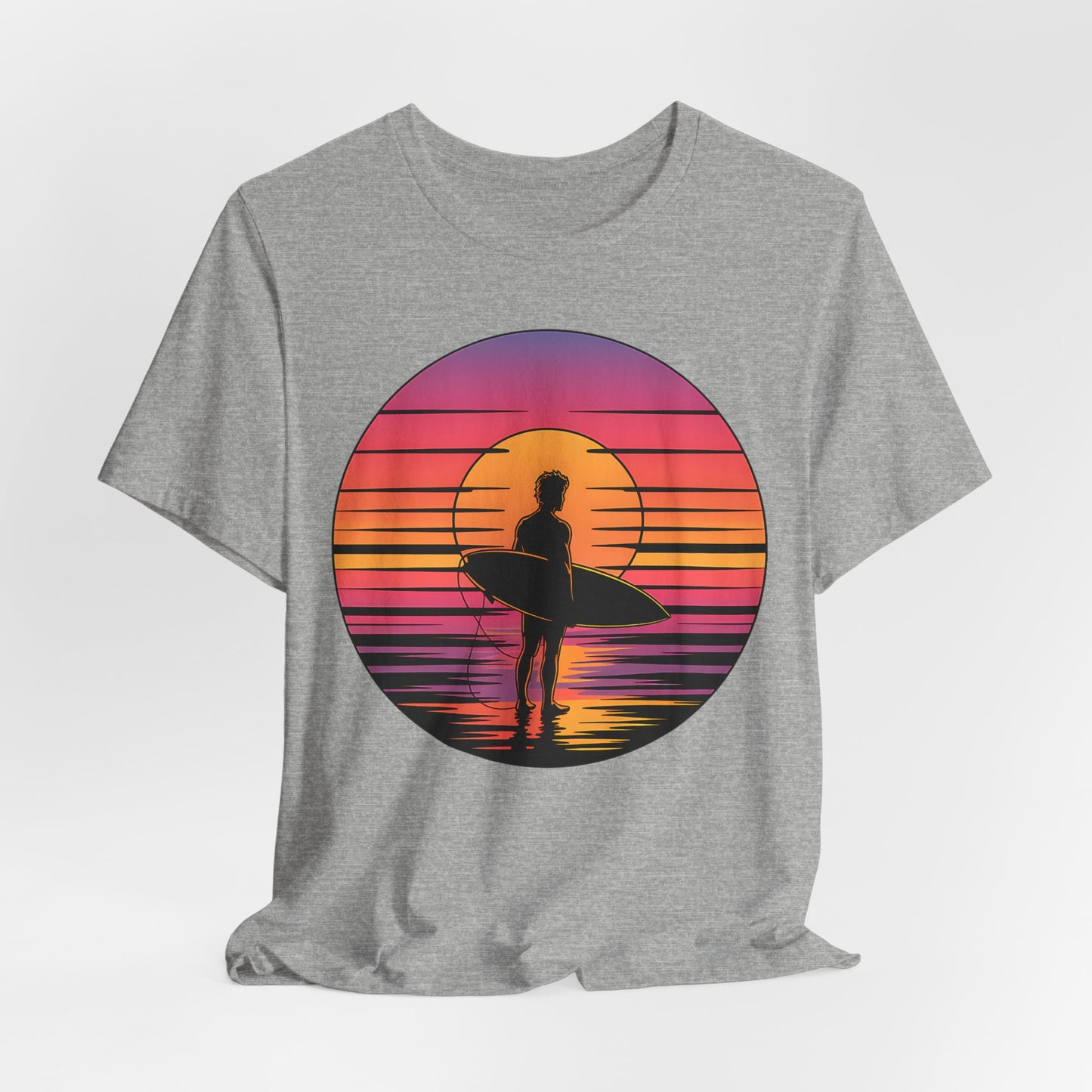 The Retro Surfing Unisex Jersey T-Shirt - Sunset Vibes is a gray tee with a circular surfer graphic by the water, set against pink, orange, and purple sunset stripes for the perfect beachy look.