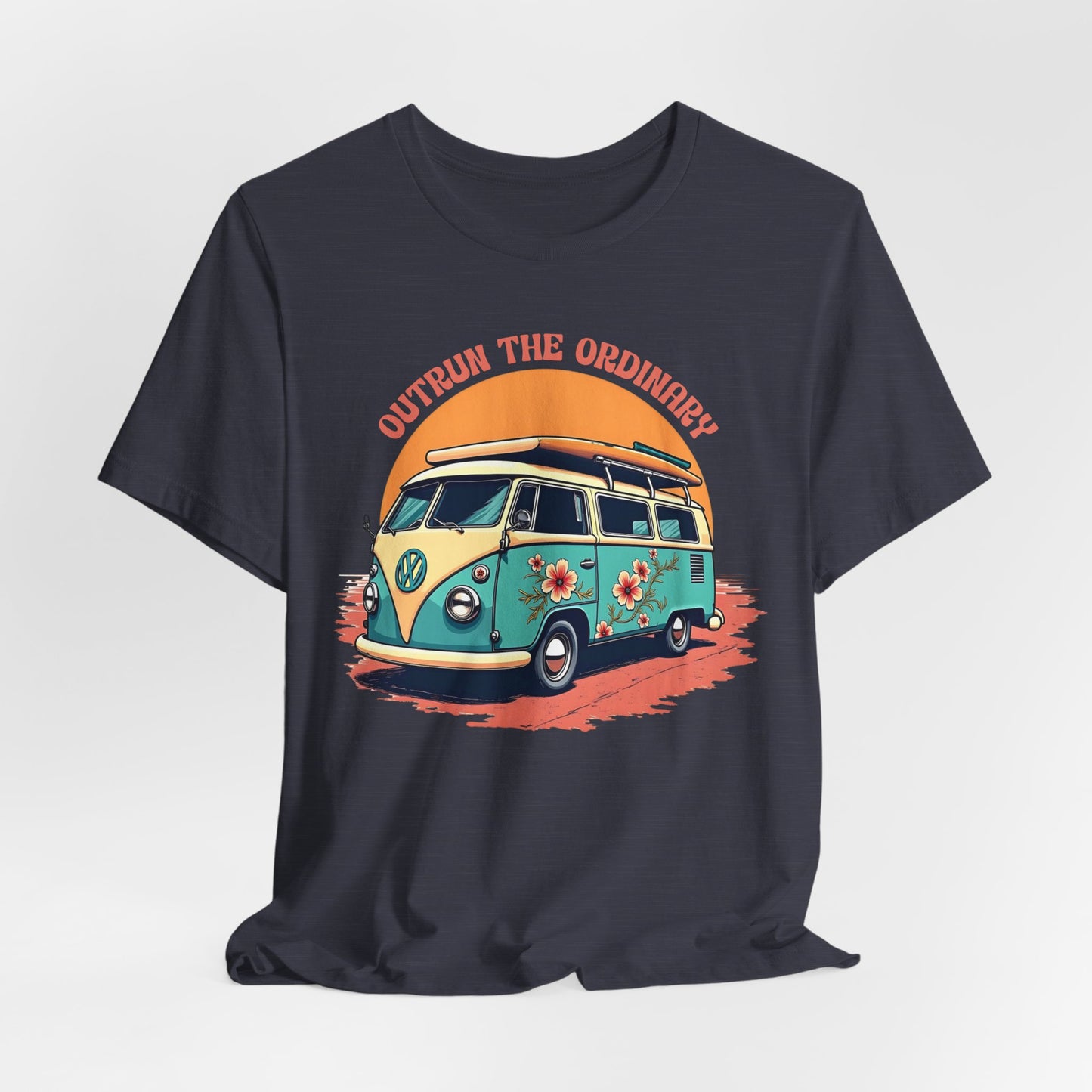 The Outrun the Ordinary Vintage VW Bus T-Shirt is a dark unisex tee with a colorful vintage van and flowers, driving under an orange sunset, and “OUTRUN THE ORDINARY” printed above the van.