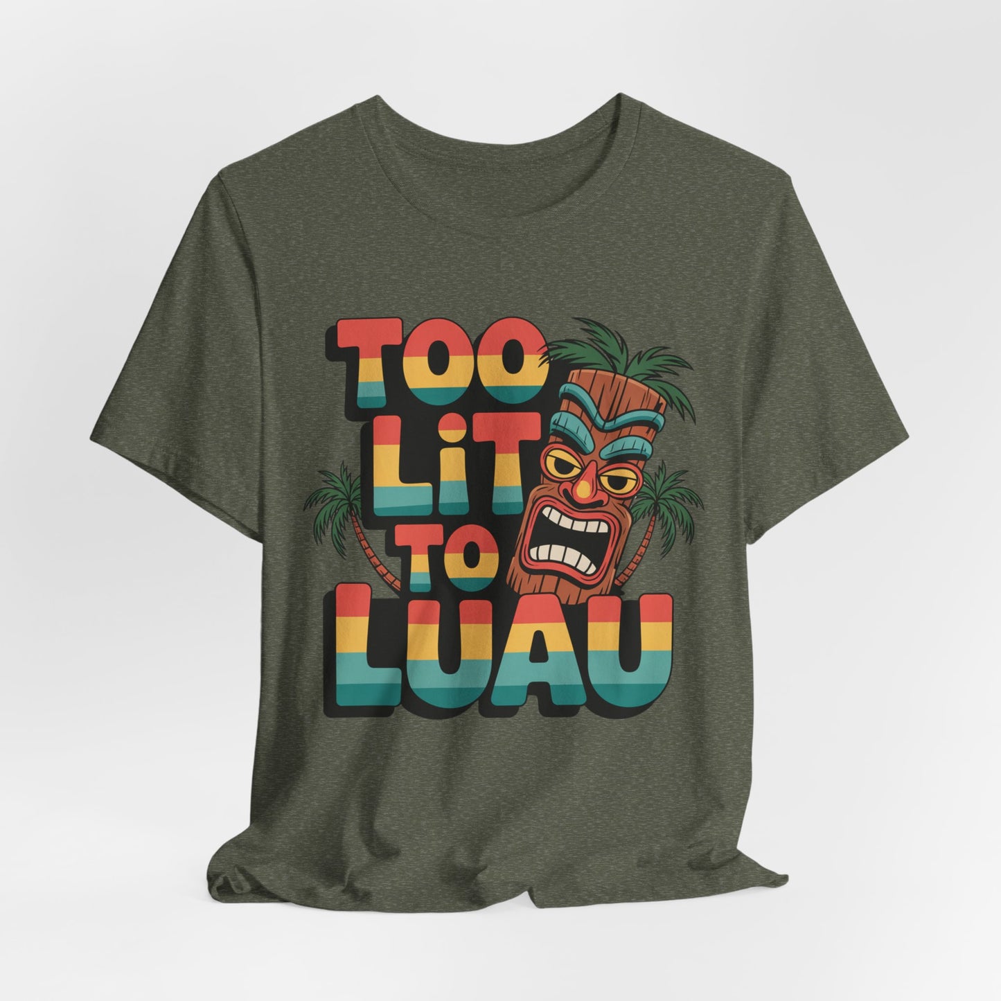 The Too Lit to Luau Unisex Jersey Short Sleeve Tiki T-Shirt features colorful text, a cartoon tiki mask, and palm trees—perfect for summer gatherings and beach vibes. Ideal as a fun Tiki Party Tee.