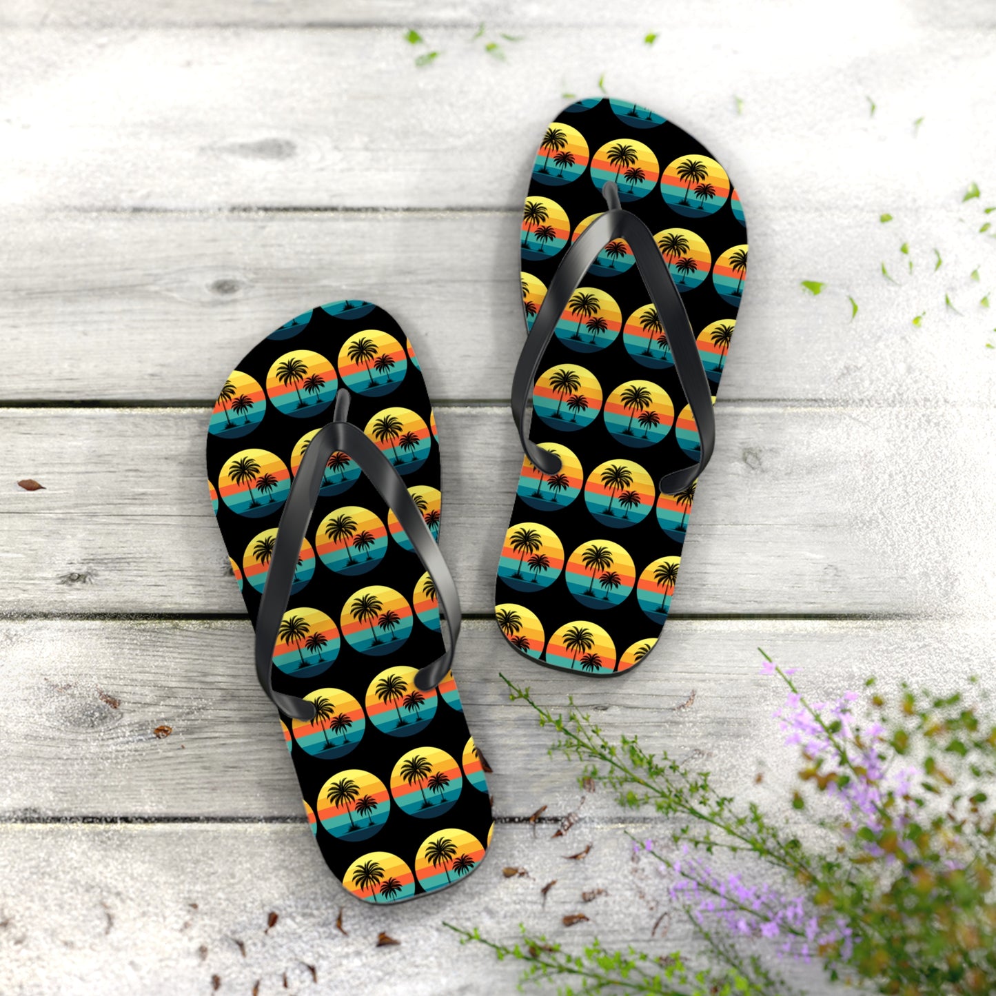 The Tropical Sunset Flip Flops - Summer Vibes with Palm Trees feature a vibrant palm tree sunset design, perfect for beach lovers wanting to brighten their summer style with playful accents of green leaves and purple flowers.