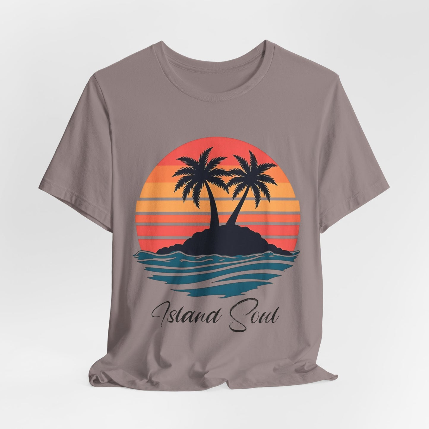 The Island Soul Unisex T-Shirt features a retro sunset design with palm trees on an island, ocean waves, and the text “Island Soul”—perfect for beachwear and relaxed island vibes.