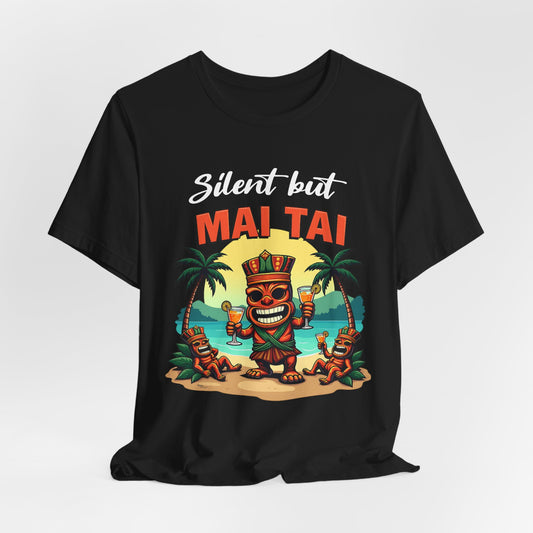 The Mai Tai Graphic Unisex Jersey Tiki T-Shirt features a vibrant cartoon tiki with Mai Tai drinks, palm trees, and beach vibes, captioned “Silent but MAI TAI”—ideal for tropical vacations.