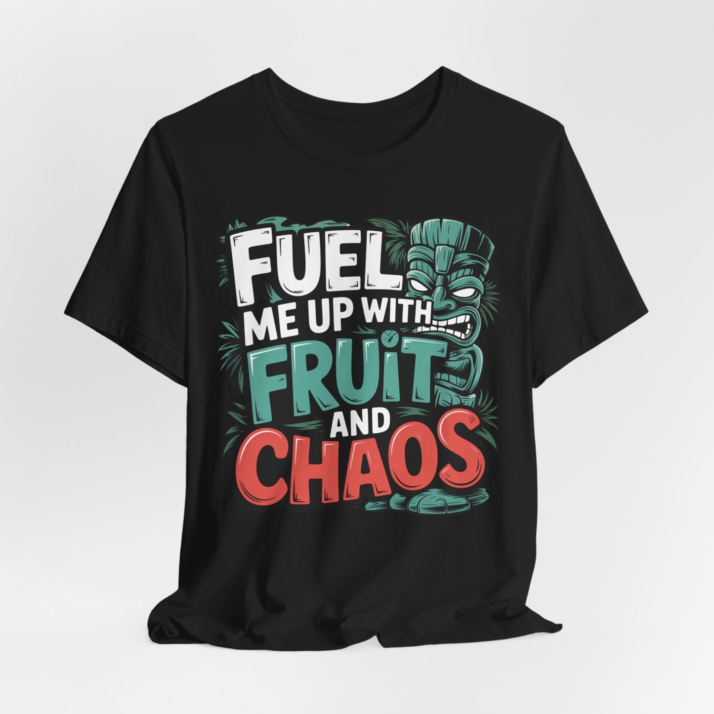 The Fuel Me Up With Fruit and Chaos Unisex Jersey Tiki T-Shirt features bold, colorful text with a tiki mask and tropical leaves—a playful graphic tee perfect for summer adventures.