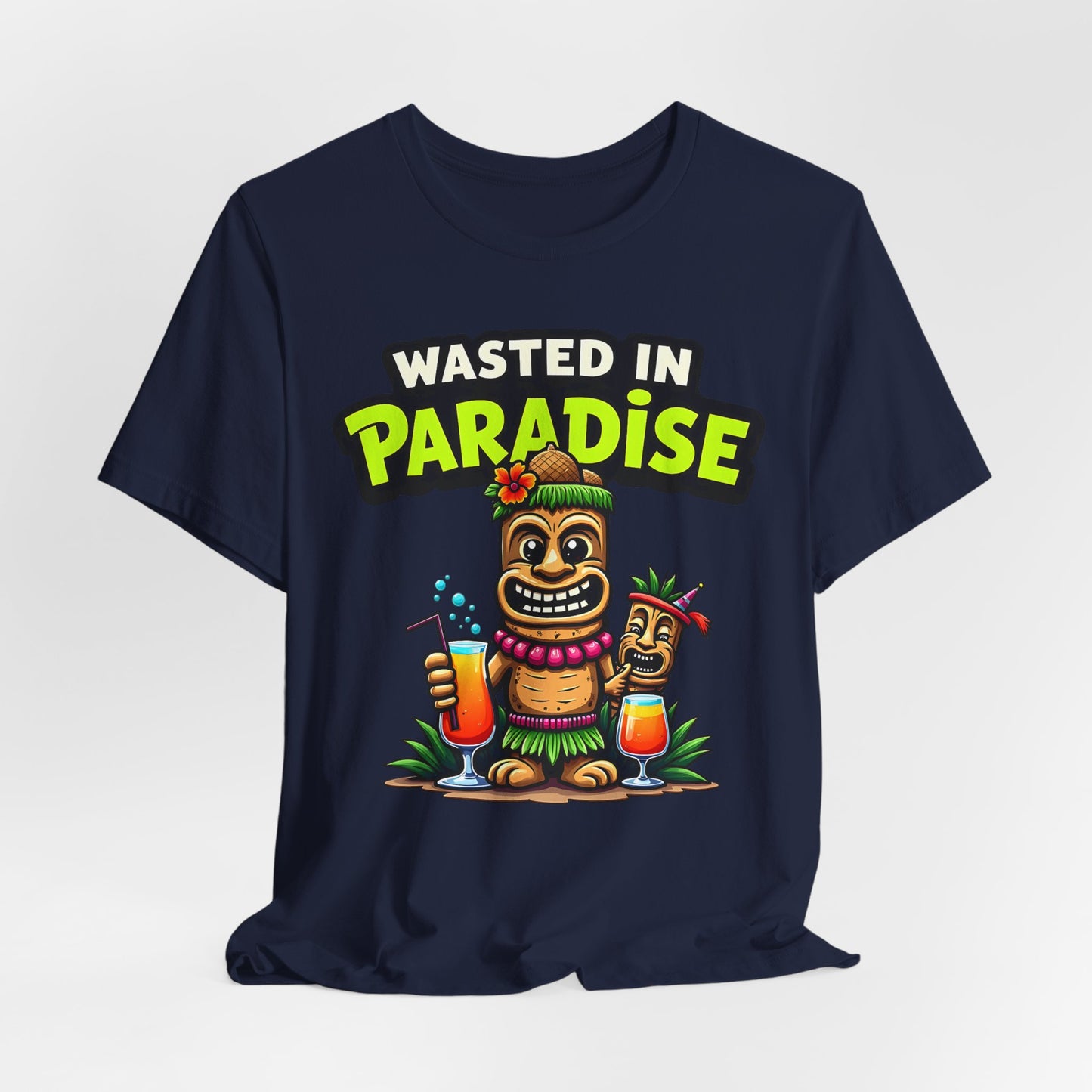 The Wasted in Paradise Graphic Tiki T-Shirt is a navy blue unisex jersey tee with two cartoon tiki characters, drinks, leis, grass skirts, and WASTED IN PARADISE text—ideal for beach parties or vacation outfits.