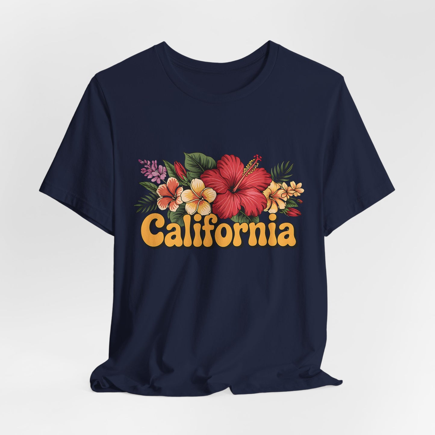 The California Floral Graphic T-Shirt features a vibrant floral design and bold yellow-orange California lettering, offered as a summer vibes unisex short sleeve tee in navy blue.