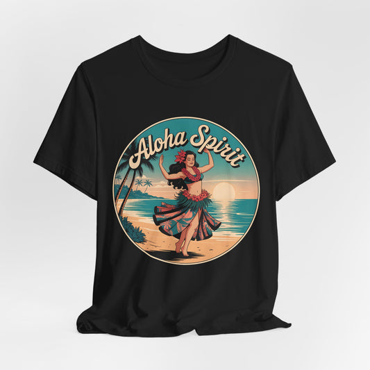 The Aloha Spirit Graphic T-Shirt–Hula Dancer T-Shirt showcases a vintage hula dancer on a sunset beach with palm trees and ocean, framed by retro “Aloha Spirit” text—ideal for island dreamers and beach lovers.
