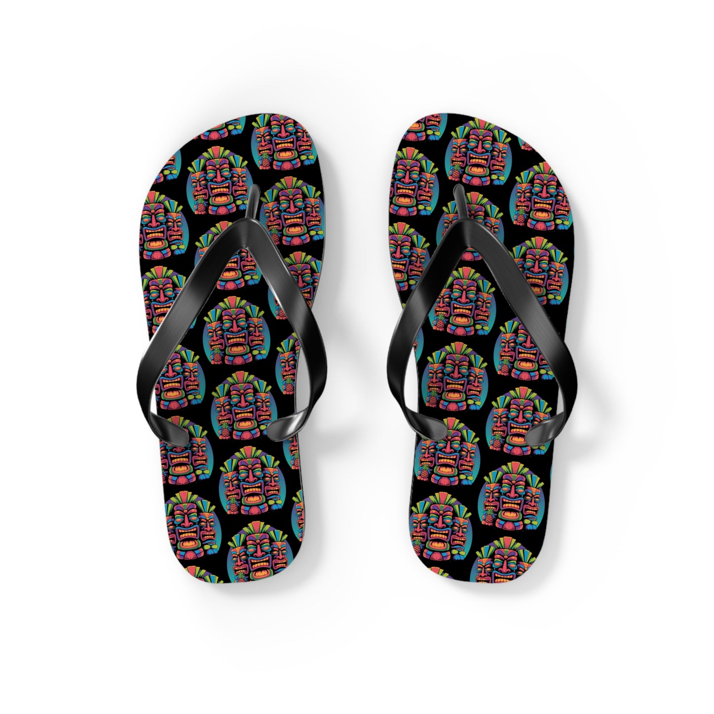 The Tropical Pineapple Flip Flops are black with a vibrant geometric face pattern on white soles, featuring solid black straps—perfect for lively summer outfits and colorful beachwear.