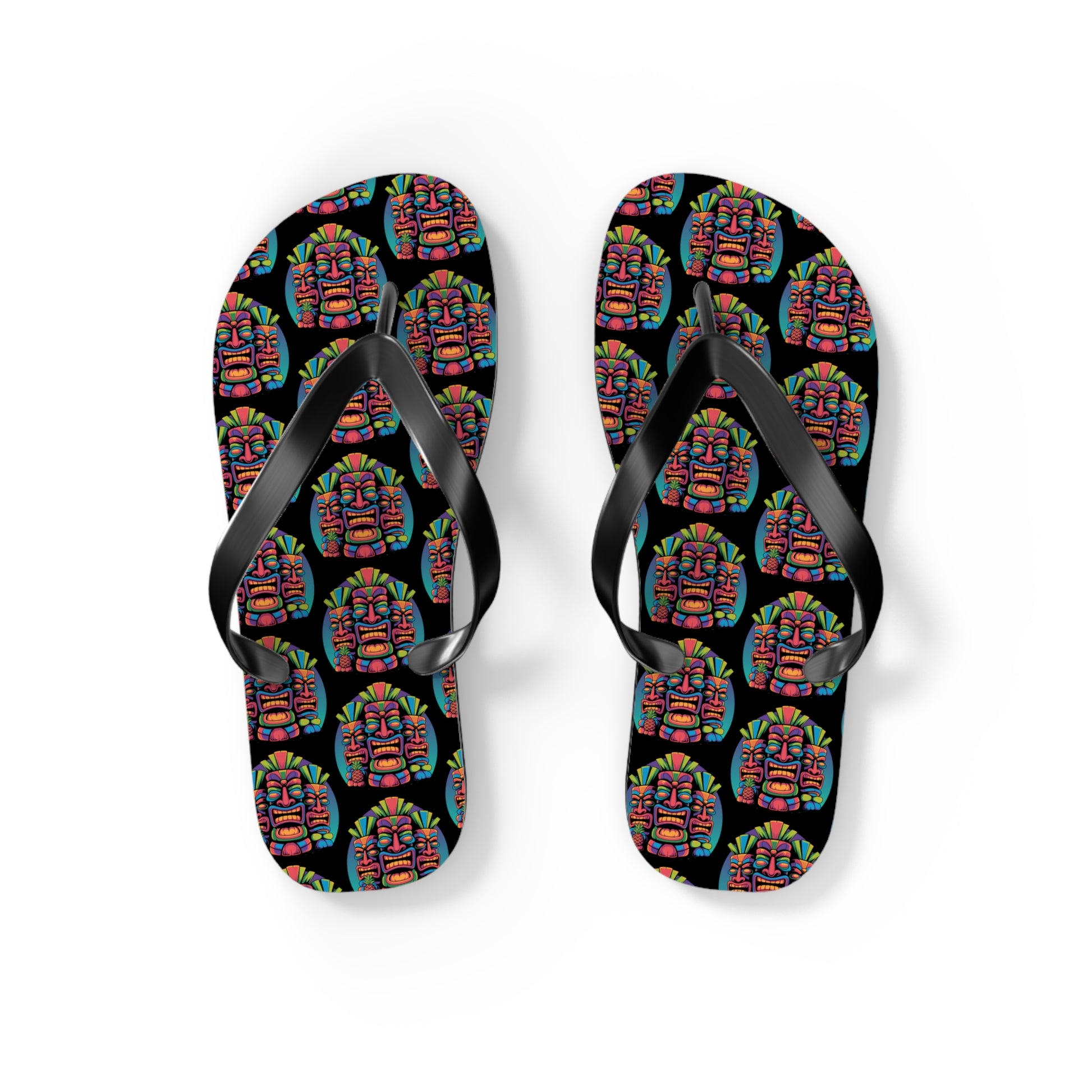 The Tropical Pineapple Flip Flops are black with a vibrant geometric face pattern on white soles, featuring solid black straps—perfect for lively summer outfits and colorful beachwear.