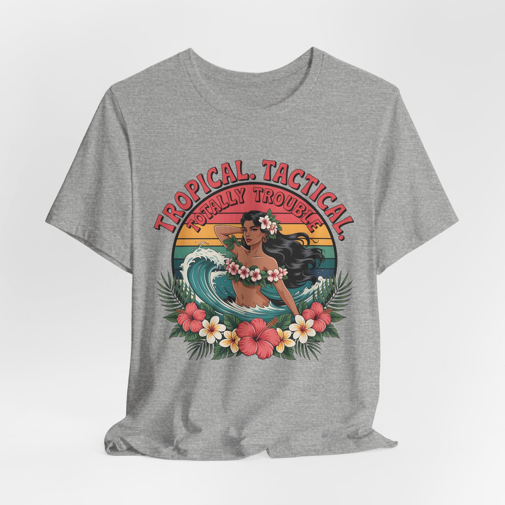 The Tropical Tactical Unisex Jersey T-Shirt - Aloha Vibes & Summer Fun features a vintage hula dancer with long black hair, surrounded by tropical flowers and leaves, with Tropical Tactical Totally Trouble text above her.