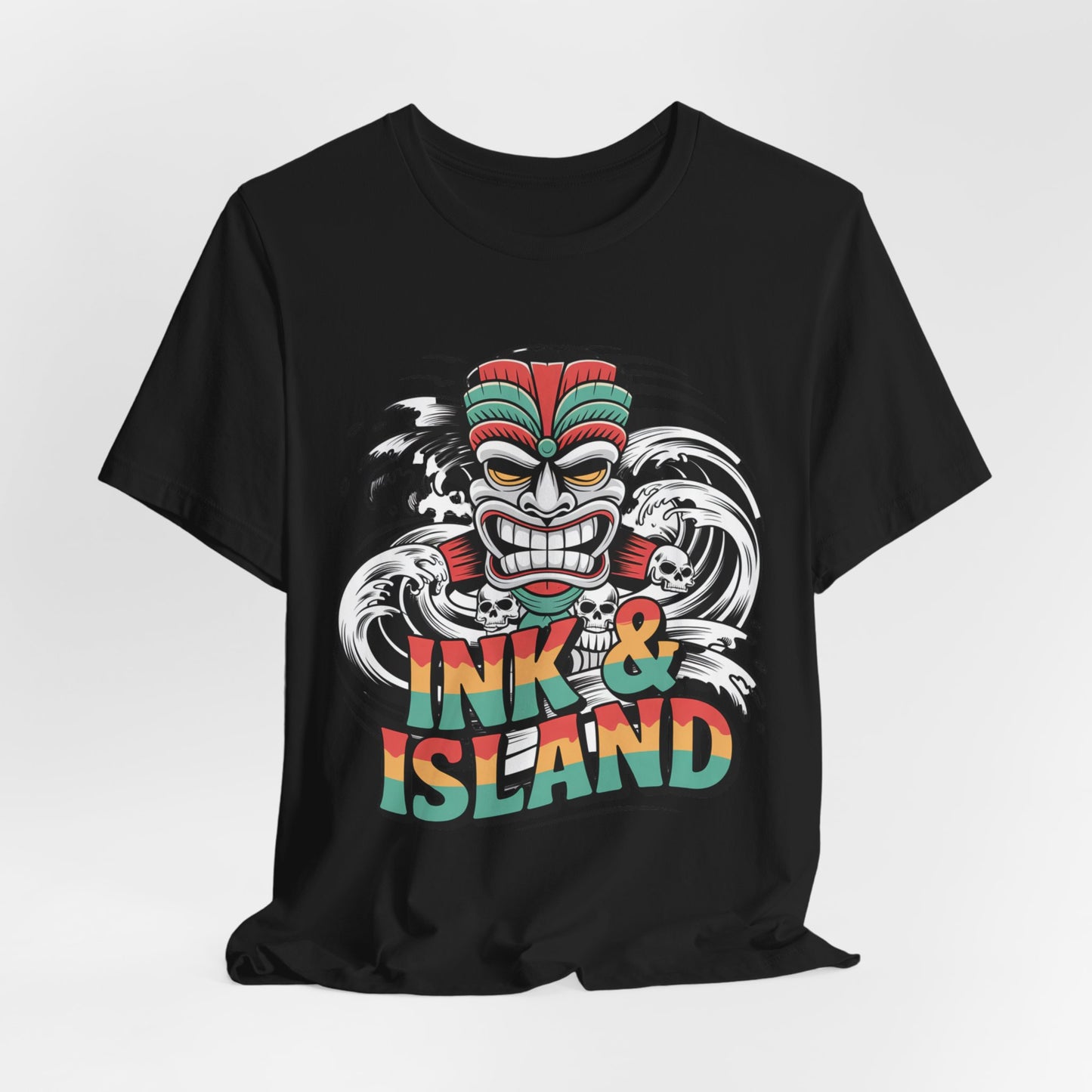 The Tropical Ink & Island Unisex Tiki T-Shirt showcases a vibrant tiki mask, bold waves, and multicolor Ink & Island text—perfect summer vibes and beachwear for those who love island culture.