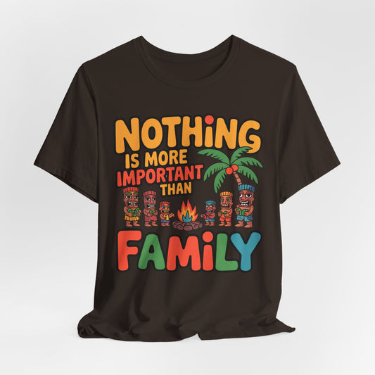 The Family Tiki Tee - Nothing is More Important Than Family Unisex T-Shirt features colorful text, tiki figures, a palm tree, and a campfire—making it a standout family statement piece.