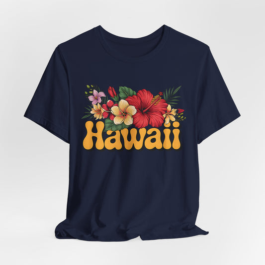 The Hawaiian Floral Unisex Tee - Beach Vibes and Island Spirit features Hawaii in bold yellow retro letters with a vibrant hibiscus, plumeria, and green leaves design on navy blue, made from ultra-soft Airlume cotton.