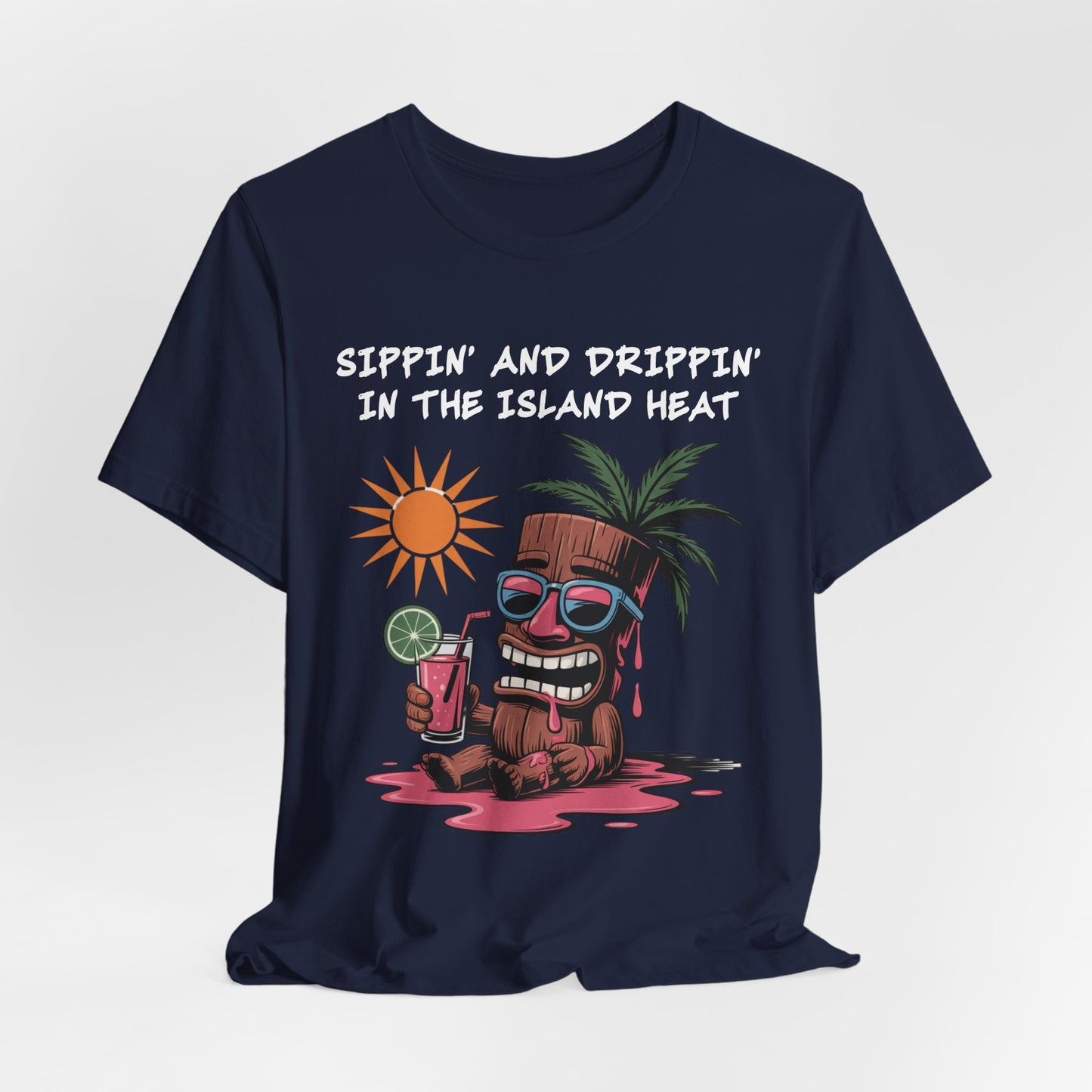 The Tropical Vibes Tiki T-Shirt features a navy blue unisex fit, playful cartoon tiki under a palm, and “Sippin’ and Drippin’ in the Island Heat” text—perfect for bringing fun island vibes to your look.