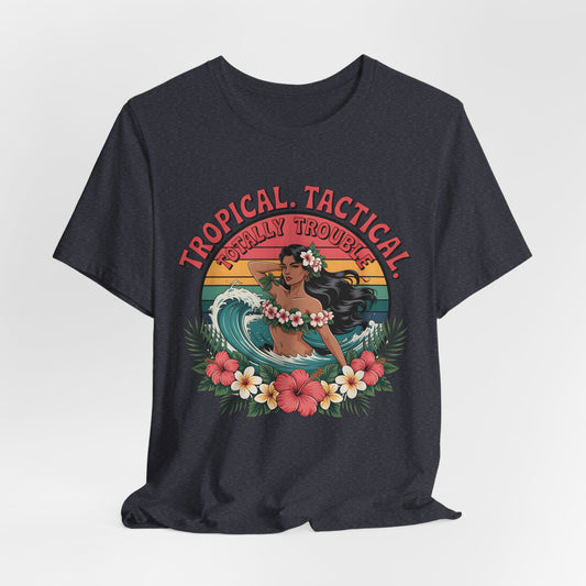 The Tropical Tactical Unisex Jersey T-Shirt - Aloha Vibes & Summer Fun features a black tee with a hula dancer, tropical flowers, ocean waves, and sunset, plus bold Tropical Tactical and Totally Trouble! graphics. Made from soft Airlume combed cotton.