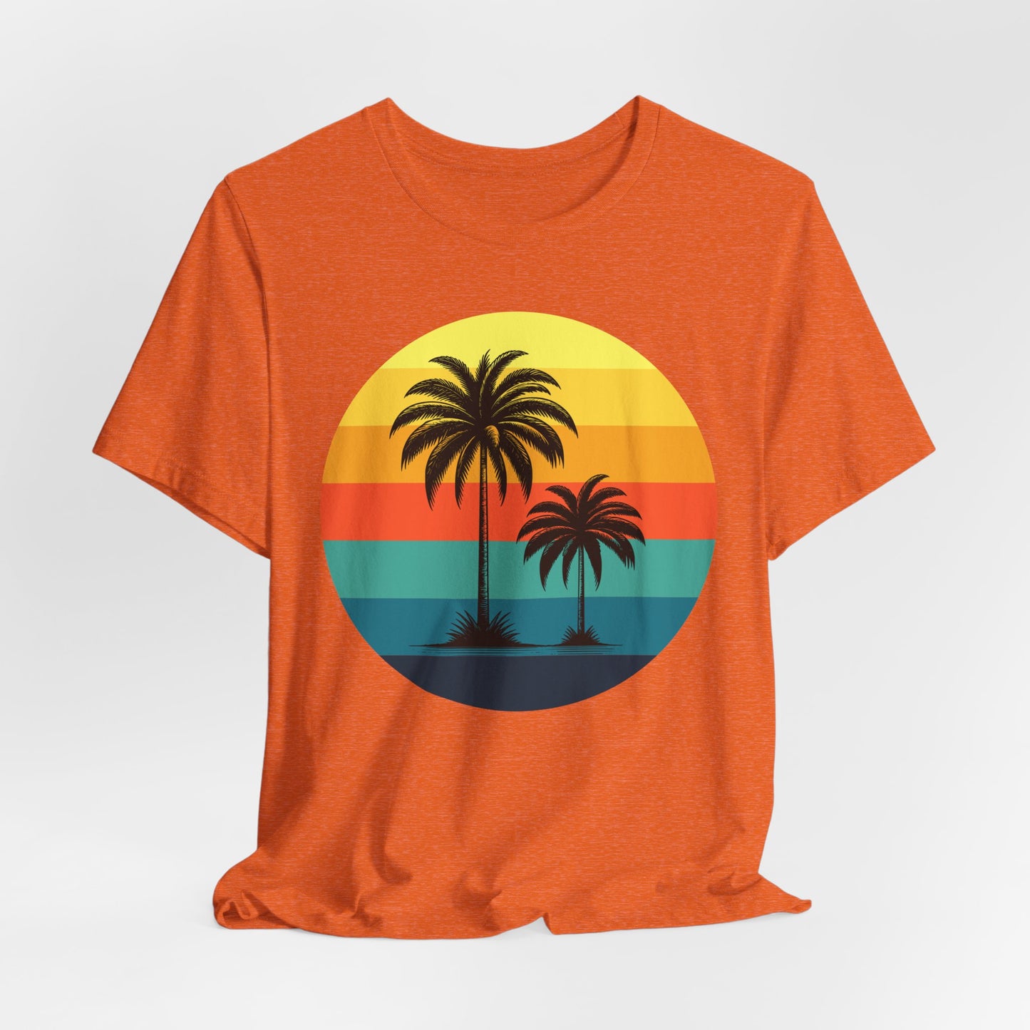 The Sunset Palm Trees Unisex Jersey T-Shirt features two silhouetted palms set in a round retro graphic with yellow, orange, red, and teal stripes—ideal for summer holidays and tropical events.