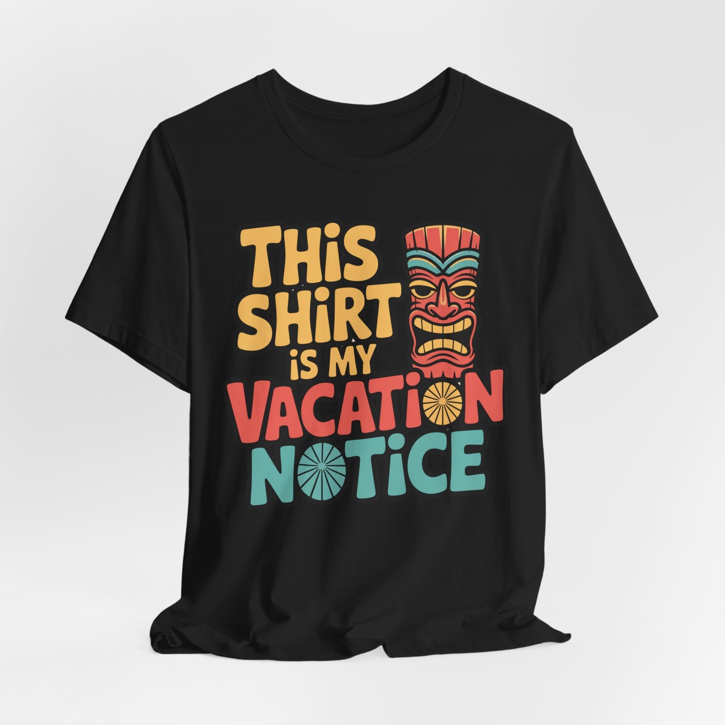 The Tiki T-Shirt - This Shirt is My Vacation Notice Funny Travel T-Shirt features a bold tiki mask and colorful yellow, red, and blue text for a playful vacation vibe on a black unisex jersey short sleeve design.