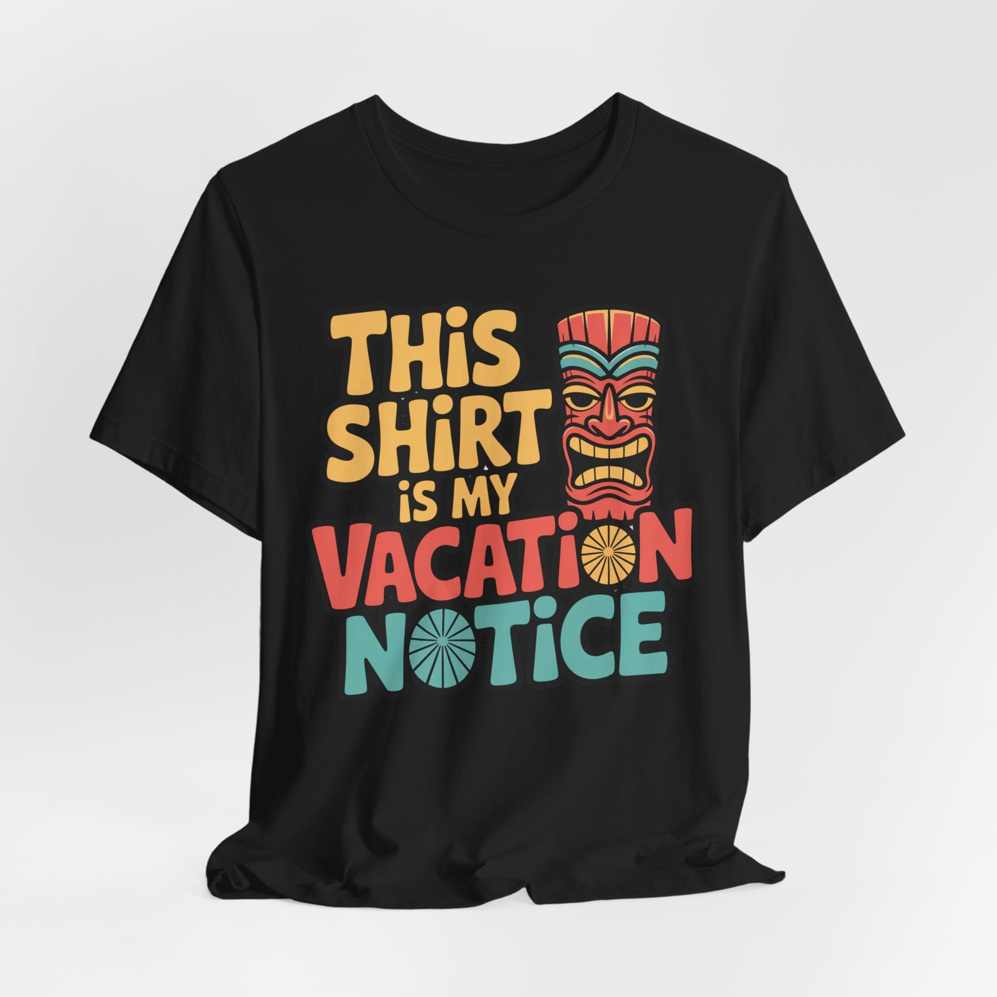 The Tiki T-Shirt - This Shirt is My Vacation Notice Funny Travel T-Shirt features a bold tiki mask and colorful yellow, red, and blue text for a playful vacation vibe on a black unisex jersey short sleeve design.