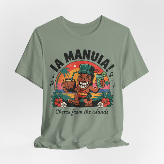 The IA MANUIA! Island Vibes Unisex Jersey Tiki T-Shirt features a green, breathable cotton tee with a vibrant cartoon tiki, drinks, flowers, palm trees, and sunset. IA MANUIA! Cheers from the islands is printed—ideal for tropical-themed events.