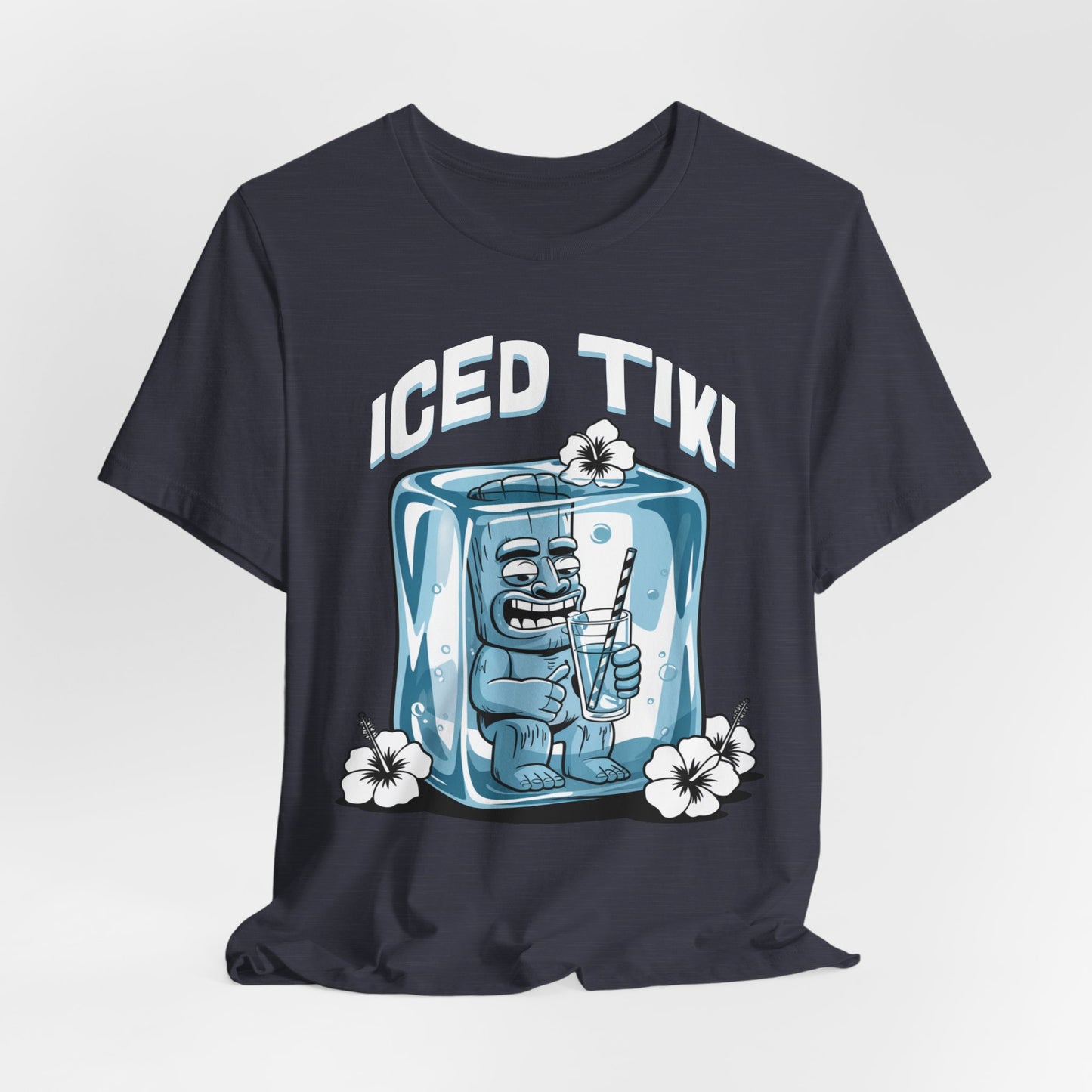 The Iced Tiki Unisex Jersey Tiki T-Shirt - Summer Vibes T-Shirt showcases a grinning tiki statue in an ice cube, sipping through a straw and surrounded by white hibiscus flowers, on breathable lightweight fabric with “ICED TIKI” above.