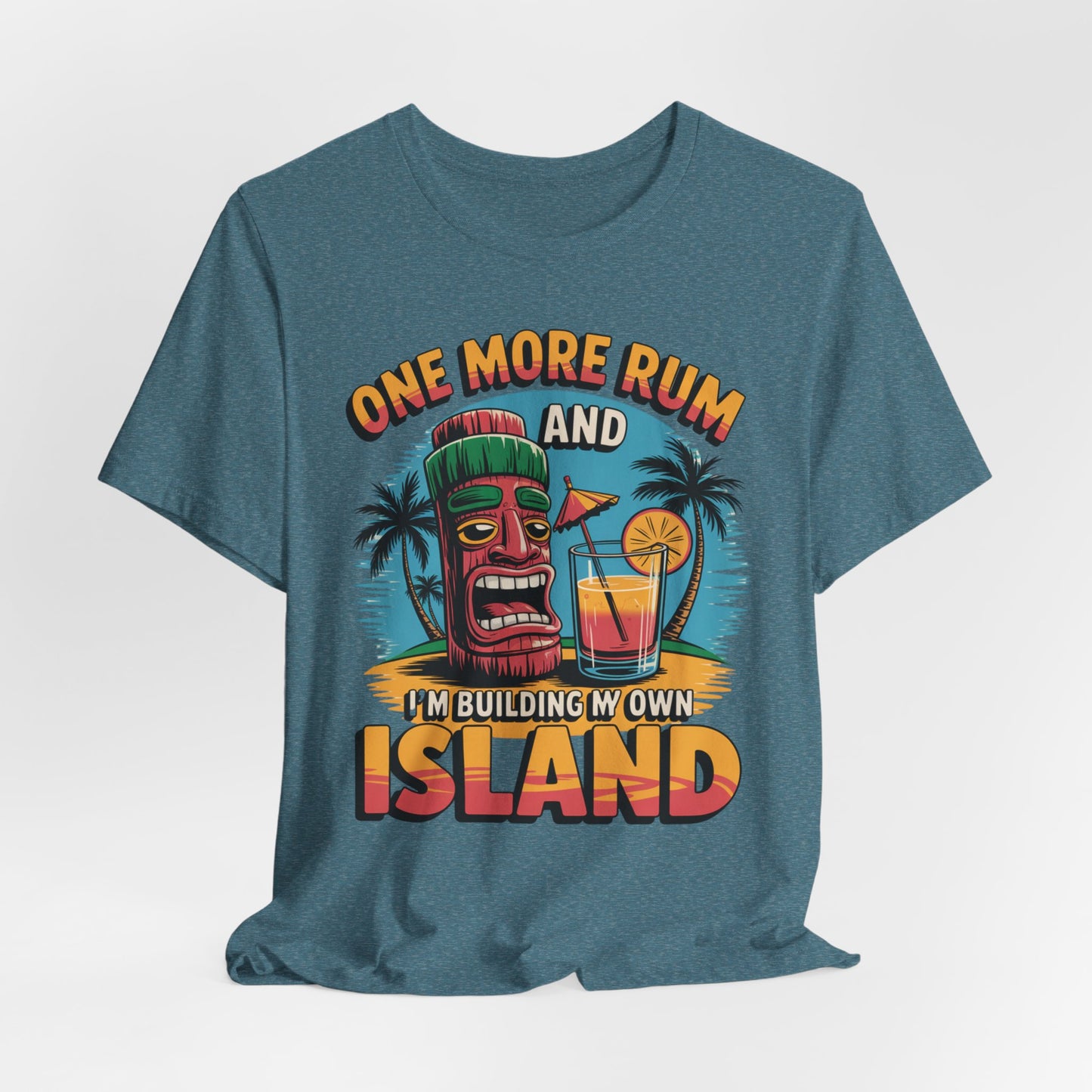 The Tropical Vacation Tiki T-Shirt features lightweight unisex fabric and a vibrant tiki mask, palm trees, and cocktail design with the text: One More Rum and Im Building My Own Island—perfect for beach lovers.