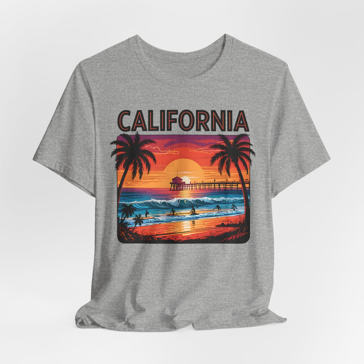 The California Sunset Unisex Jersey T-Shirt features California above a vibrant sunset beach with palm trees, pier, surfers, and reflections—perfect vintage beach vibe for casual style lovers.